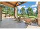 Gorgeous covered patio with stone pillars and a built in fireplace with seating at 5722 S Benton Way, Littleton, CO 80123