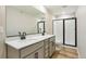 Modern bathroom featuring double sinks, a large mirror, and a walk-in shower at 17881 East 94Th Ave, Commerce City, CO 80022