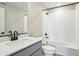 Modern bathroom featuring white subway tile, quartz counters, and black fixtures at 17881 East 94Th Ave, Commerce City, CO 80022