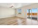 Spacious bedroom featuring light wood flooring, a ceiling fan, and a sliding glass door at 17881 East 94Th Ave, Commerce City, CO 80022