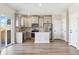 Modern kitchen featuring stainless appliances, an island, and sleek wood flooring at 17881 East 94Th Ave, Commerce City, CO 80022