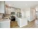 Modern kitchen featuring an island, stainless appliances, and light gray cabinets at 17881 East 94Th Ave, Commerce City, CO 80022
