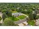 Aerial view shows a home with a well-manicured lawn, and mature trees within a tree filled neighborhood at 5698 Green Oaks Dr, Greenwood Village, CO 80121