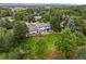 Aerial view showcases the home's expansive green space, mature trees, and neighborhood surroundings at 5698 Green Oaks Dr, Greenwood Village, CO 80121