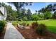 Beautifully landscaped backyard with a stone-lined walkway and manicured lawn at 5698 Green Oaks Dr, Greenwood Village, CO 80121
