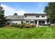 Expansive backyard featuring a well-manicured lawn, patio with seating, and lush landscaping, perfect for outdoor living at 5698 Green Oaks Dr, Greenwood Village, CO 80121