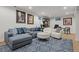 Finished basement with a large sectional sofa and custom area rug at 5698 Green Oaks Dr, Greenwood Village, CO 80121
