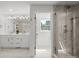 Bathroom with double vanity, marble floors, and a frameless glass shower at 5698 Green Oaks Dr, Greenwood Village, CO 80121