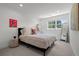Cozy bedroom with neutral colors, a large window, side table and a full length mirror at 5698 Green Oaks Dr, Greenwood Village, CO 80121