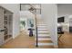 Inviting foyer with wood floors and staircase with a black iron railing at 5698 Green Oaks Dr, Greenwood Village, CO 80121