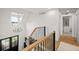 Hallway with staircase, natural light, hardwood floors, and a modern chandelier at 5698 Green Oaks Dr, Greenwood Village, CO 80121