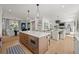 Open floor plan view of kitchen featuring island with cooktop open to living and dining areas at 5698 Green Oaks Dr, Greenwood Village, CO 80121