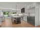 Bright kitchen featuring stainless steel appliances, a center island with wine cooler, and large window with backyard view at 5698 Green Oaks Dr, Greenwood Village, CO 80121
