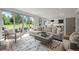 Open-concept living room with sliding glass doors and view to the backyard at 5698 Green Oaks Dr, Greenwood Village, CO 80121