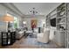 Comfortable living room with large window and built-in shelving at 5698 Green Oaks Dr, Greenwood Village, CO 80121