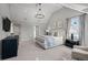 Main bedroom suite featuring a large bed, sitting area, vaulted ceilings, and ample natural light from the windows at 5698 Green Oaks Dr, Greenwood Village, CO 80121