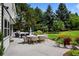 Serene patio with an outdoor dining and seating area amid lush greenery at 5698 Green Oaks Dr, Greenwood Village, CO 80121