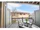 Relaxing balcony with comfortable seating and a view of the neighborhood homes against a blue sky at 2958 N Xenia St, Denver, CO 80238