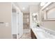 A full bathroom showcases a shower and long vanity with double doors to a walk-in closet at 2958 N Xenia St, Denver, CO 80238