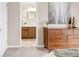 Bright bedroom featuring a dresser and an open doorway view into a bathroom at 2958 N Xenia St, Denver, CO 80238