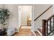 Welcoming entryway with hardwood floors, a staircase, and a decorative table at 2958 N Xenia St, Denver, CO 80238