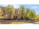 Attractive brick townhomes boast mature trees and well-maintained landscaping at 2958 N Xenia St, Denver, CO 80238