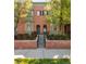 Beautiful brick townhome featuring classic design, landscaped yard, and steps to front door at 2958 N Xenia St, Denver, CO 80238