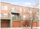 Multi-level exterior showcasing balconies and garage access; the building is painted shades of orange and brown at 2958 N Xenia St, Denver, CO 80238