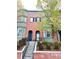Attractive red brick townhome with bay windows, complemented by mature trees and landscaped garden at 2958 N Xenia St, Denver, CO 80238