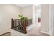 Hallway with carpet flooring, wood railings, and plant which enhances the overall appeal of this well-maintained home at 2958 N Xenia St, Denver, CO 80238