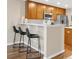 Modern kitchen bar area with stainless steel appliances, barstool seating, and sleek countertop at 2958 N Xenia St, Denver, CO 80238