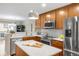 Modern kitchen with stainless steel appliances, white countertops, and wood cabinets at 2958 N Xenia St, Denver, CO 80238
