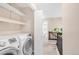 Laundry area featuring white Samsung washer and dryer next to an open doorway at 2958 N Xenia St, Denver, CO 80238