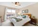 Comfortable bedroom with a large bed, decorative pillows, balcony access, and natural light from the sliding door at 2958 N Xenia St, Denver, CO 80238