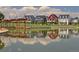 Beautiful waterfront homes reflected in a serene lake, showcasing colorful facades and attractive architectural details at 2958 N Xenia St, Denver, CO 80238