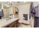 Bright bathroom with a vanity, mirror, and shower, offering a clean and functional space at 5404 W Canyon Trl # C, Littleton, CO 80128