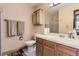 Well-lit bathroom featuring a vanity with a sink, mirror, and a cabinet at 5404 W Canyon Trl # C, Littleton, CO 80128