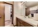 Bathroom featuring a vanity with a sink, and a view to a separate room at 5404 W Canyon Trl # C, Littleton, CO 80128