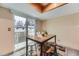 Bright breakfast nook featuring a wooden table, modern stools, and sliding door access to the outdoor balcony at 5404 W Canyon Trl # C, Littleton, CO 80128