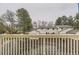 A view from the balcony of a townhouse featuring a front-facing garage and mature trees at 5404 W Canyon Trl # C, Littleton, CO 80128