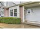 Charming front entrance featuring brick accents, a welcoming door mat, and well-maintained landscaping at 5404 W Canyon Trl # C, Littleton, CO 80128