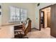 Bright home office with a desk, chair, window, and closet at 5404 W Canyon Trl # C, Littleton, CO 80128