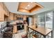 Bright kitchen featuring light wood cabinetry, stainless steel appliances, and a door to a balcony at 5404 W Canyon Trl # C, Littleton, CO 80128