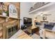 Cozy living room boasts a floor-to-ceiling wood accent wall, fireplace, and vaulted ceilings at 5404 W Canyon Trl # C, Littleton, CO 80128