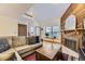 Inviting living room featuring a fireplace, wood floors, and large windows for natural light at 5404 W Canyon Trl # C, Littleton, CO 80128