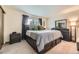 Spacious main bedroom featuring a comfortable bed, dresser, a large window, and soft carpet flooring at 5404 W Canyon Trl # C, Littleton, CO 80128