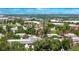Wide aerial view of residential area with lush tree coverage, buildings and mountain views at 12156 Melody Dr # 201, Westminster, CO 80234