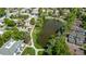 Aerial view of apartments surrounding pond and walking path with mature trees at 12156 Melody Dr # 201, Westminster, CO 80234
