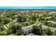 Scenic aerial shot of the apartment complex surrounded by lush greenery and a tranquil pond at 12156 Melody Dr # 201, Westminster, CO 80234