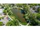 Scenic aerial view of a tranquil pond surrounded by lush greenery and walking paths in a residential community at 12156 Melody Dr # 201, Westminster, CO 80234